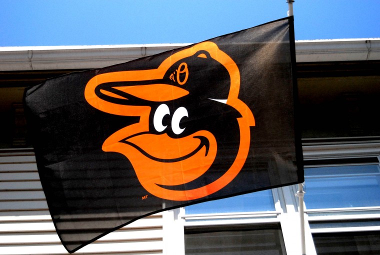 baltimore orioles flag hanging on side of house