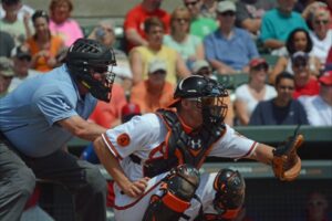 orioles catcher kneeling with referee behind him