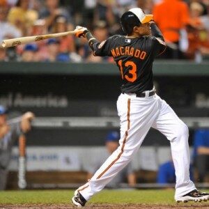 orioles batter with bat behind back after hitting baseball