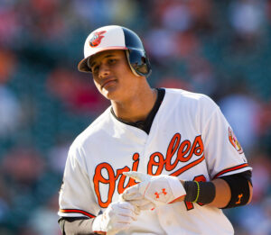 close up shot of orioles player about to take glove off