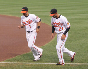 two orioles players running with heads down