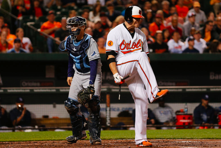 orioles player holding leg up after breaking baseball bat