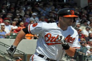 player running bases with crowd in background