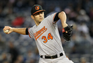 pitcher for orioles looking forward about to throw pitch