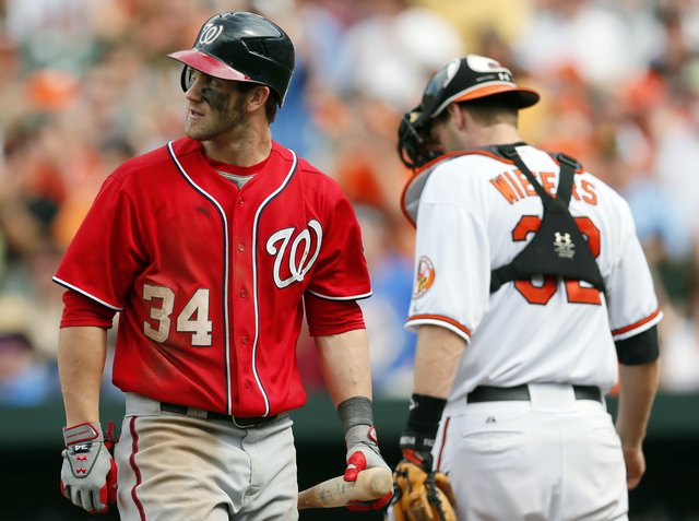 batter and catcher from opposite teams walking by each other