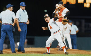 old picture of former orioles players and refs on mound