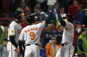 three orioles players two giving high five to each other