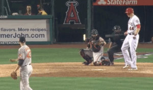 angels baseball palyer looking back at catcher at home plate