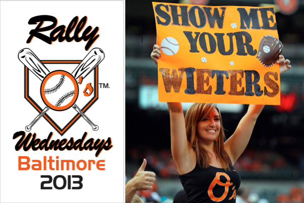 girl standing wearing orioles tank holding a sign up