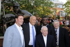 picture of five former orioles players posed in front of cal ripken statue
