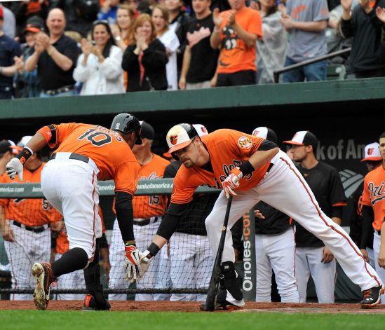 orioles players jones and matt slap hands going into dugout