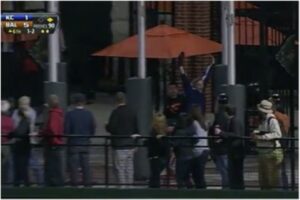 fan cheering with arms up in camden yards patio area