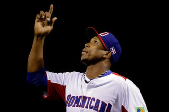 baseball player on dominican republic team pointing up to sky