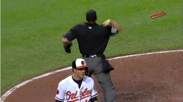 orioles player standing by referee at game