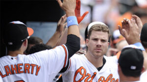 orioles players davis and flaherty high fiving in dugout