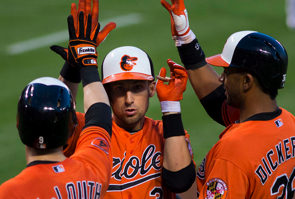 two orioles players high fiving other player