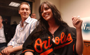 orioles players wife wearing jersey smiling in room holding arm up