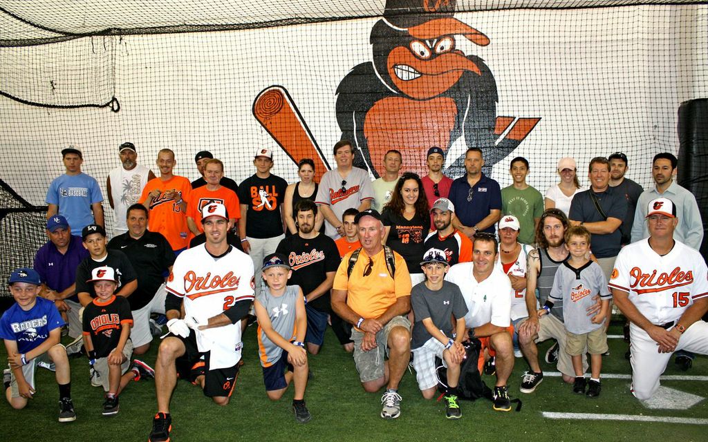 group shot of kids and parents with orioles players