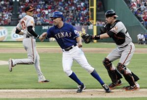 texas player getting tagged out by orioles catcher