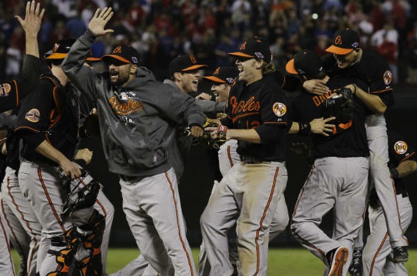 orioles team jumping and giving each other high fives