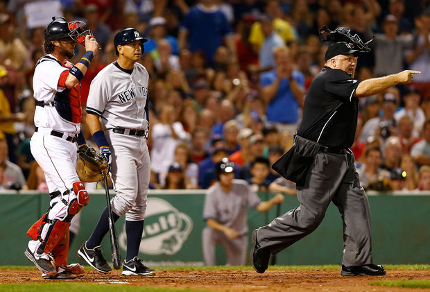 yankees player with boston catcher and referee