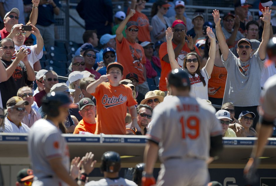 orioles fans standing up with arms raised at petco park