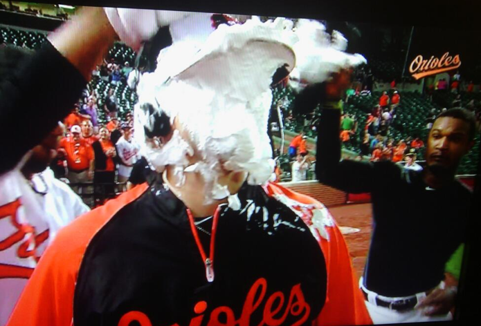 orioles player with pie all over face and hat