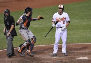 orioles batter standing next to catcher and referee