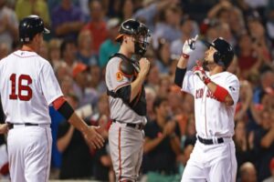 two red sox players with orioles catcher