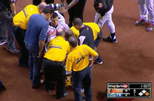 orioles player on stretcher surrounded by medics on baseball field