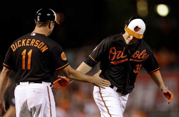 orioles player about to smack hands with dickerson while running by