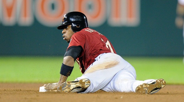 baseball player laying on ground on base