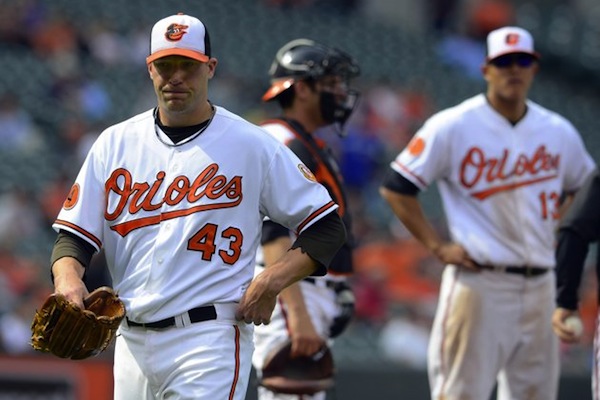 orioles player walking away from team member and catcher