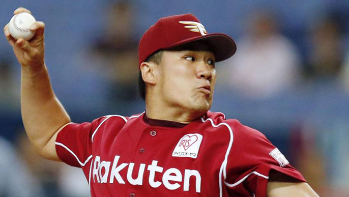 asian pitcher in baseball about to throw ball