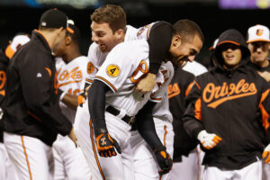 orioles players standing around one with arm over another