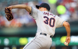 baseball player winding up for pitch