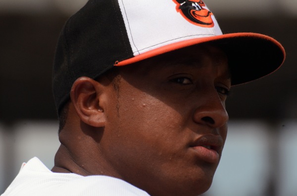orioles player with baseball cap on looking off to side