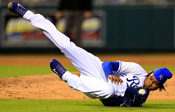 ball player on ground catching baseball