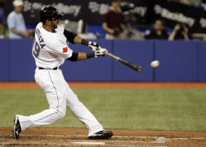 baseball player at bat about to hit baseball