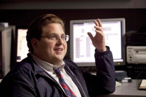 guy sitting in front of computer with arm up