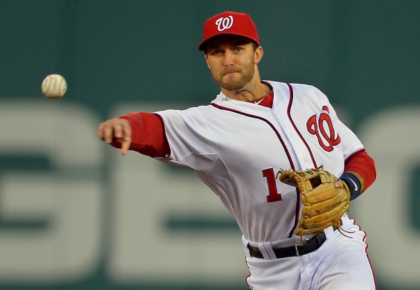 ball player looking directly at baseball after throwing pitch