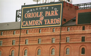 brick building with welcome to camden yards sign at top