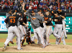 orioles team giving high fives on baseball mound