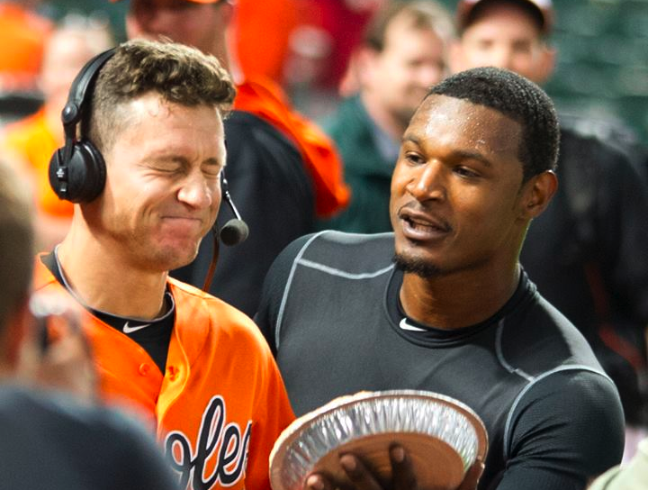 orioles player wearing headset about to have pie thrown in face