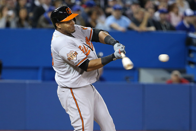 orioles player about to hit baseball with bat