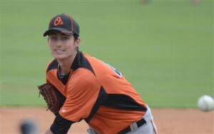 orioles player tim berry with arm over body after pitch