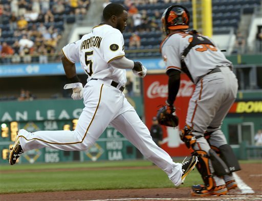 baseball player running into home plate with orioles catcher