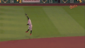 orioles player up in air trying to catch ball