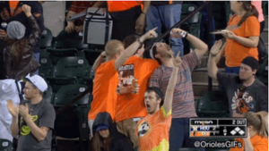 orioles fans in stands with arms up celebrating