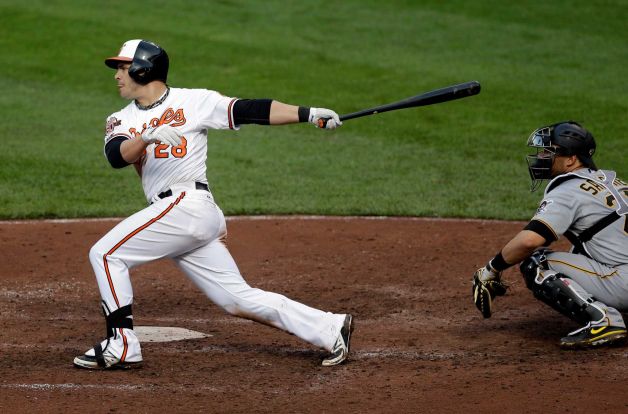 orioles player pearce in front of catcher after hitting baseball